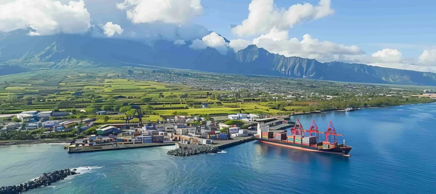 large-ship-is-docked-water-with-mountains-background-min